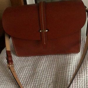 Dooney &Bourke leather shoulder bag. The strap is not very long. Gorgeous bag!!